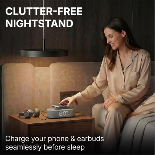 fabric digital alarm clock for bedroom, wireless charging shown in use