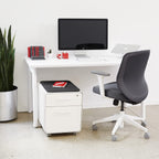 Poppin Mobile Mini Sittable Stow Rolling File Cabinet - White with Dark Gray Seat Cushion. Two Locking Drawers and One Key Lock. Two Keys Included. One Utility Drawer and One Hanging File Drawer