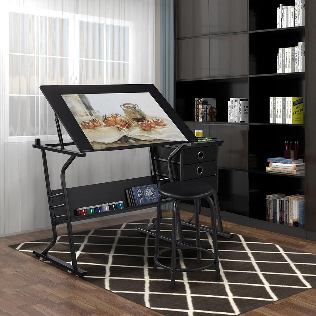 Yaheetech Tilting Drafting Table Art Craft Desk with Stool, Drawers, Black | Steel frame and MDF top adjusts 0-40° for drawing or diamond painting; 3 drawers and shelf organize supplies in small spaces.